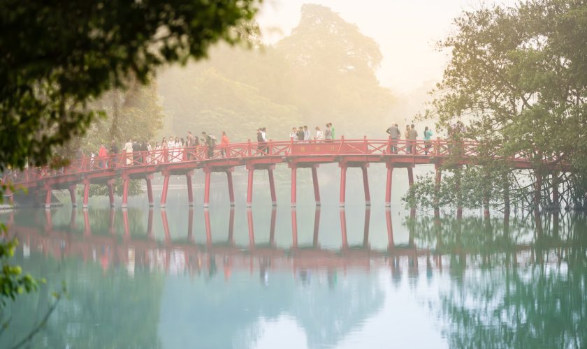 Bridge with people in fog. Hanoi, Vietnam.